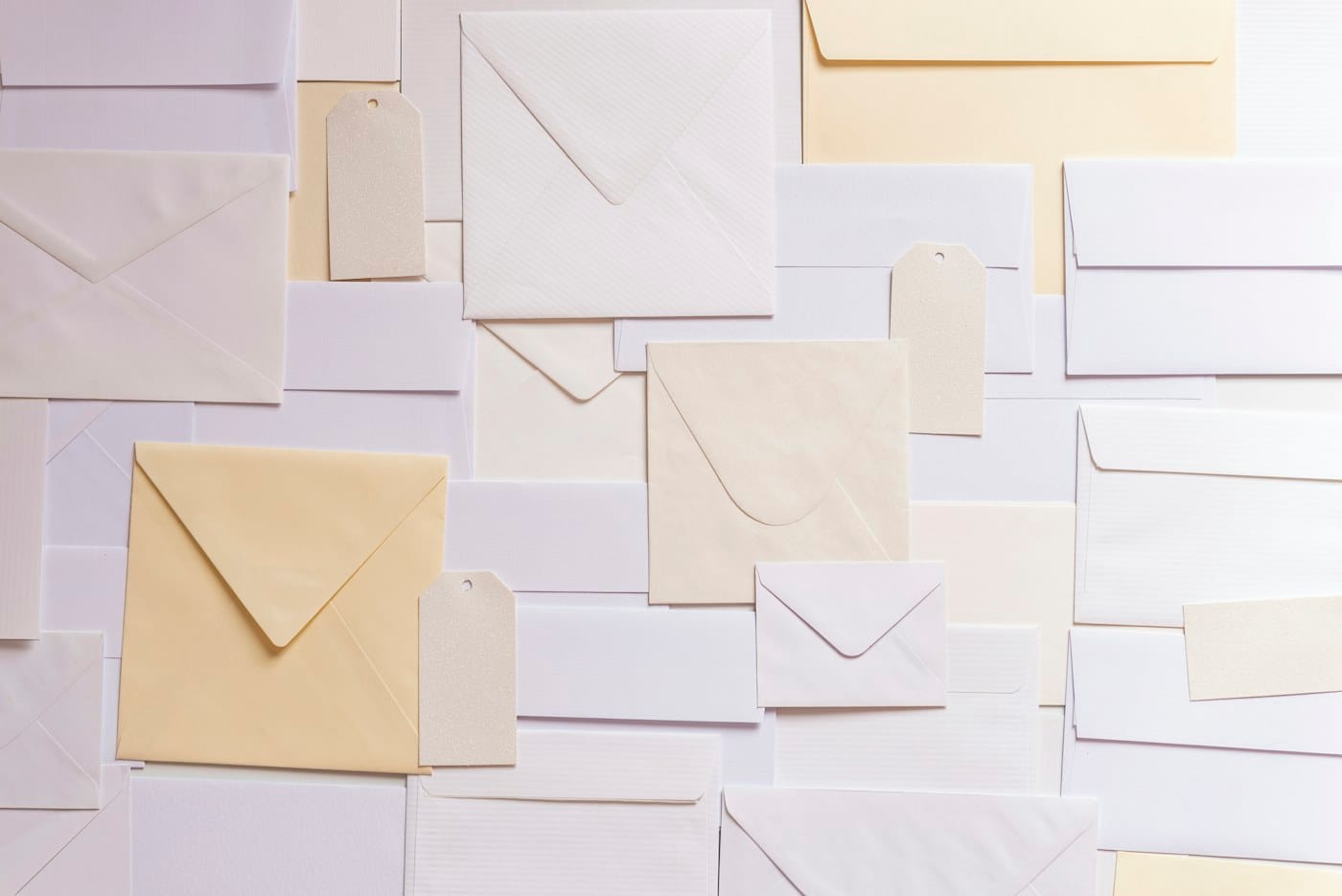 Envelopes in several shapes and pastel colors, including square ones